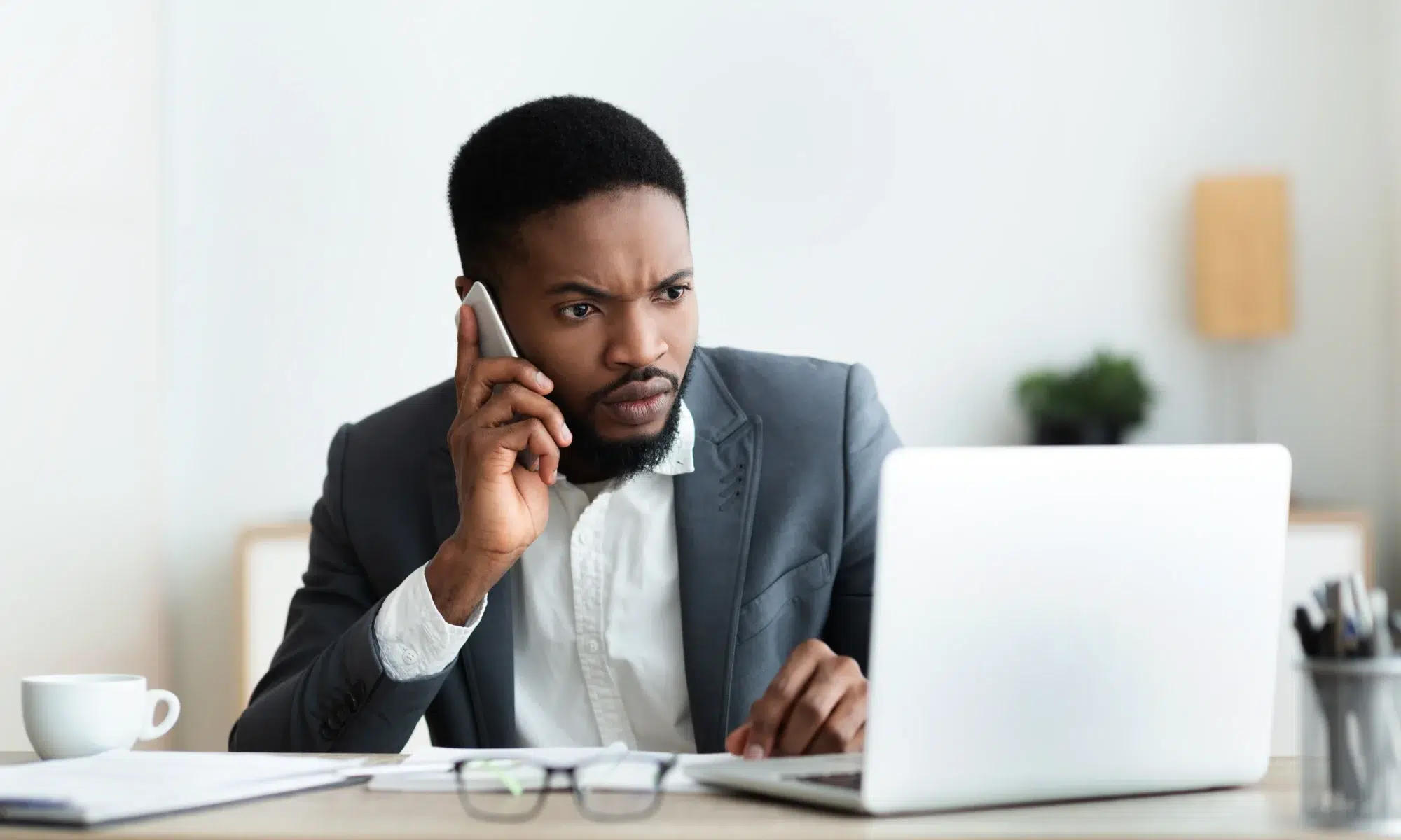 Guy talking on a phone about data security plan for his company after a breach