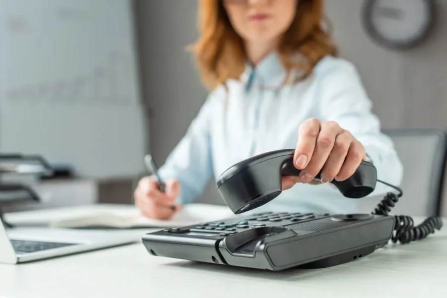 Woman hanging off her telephone