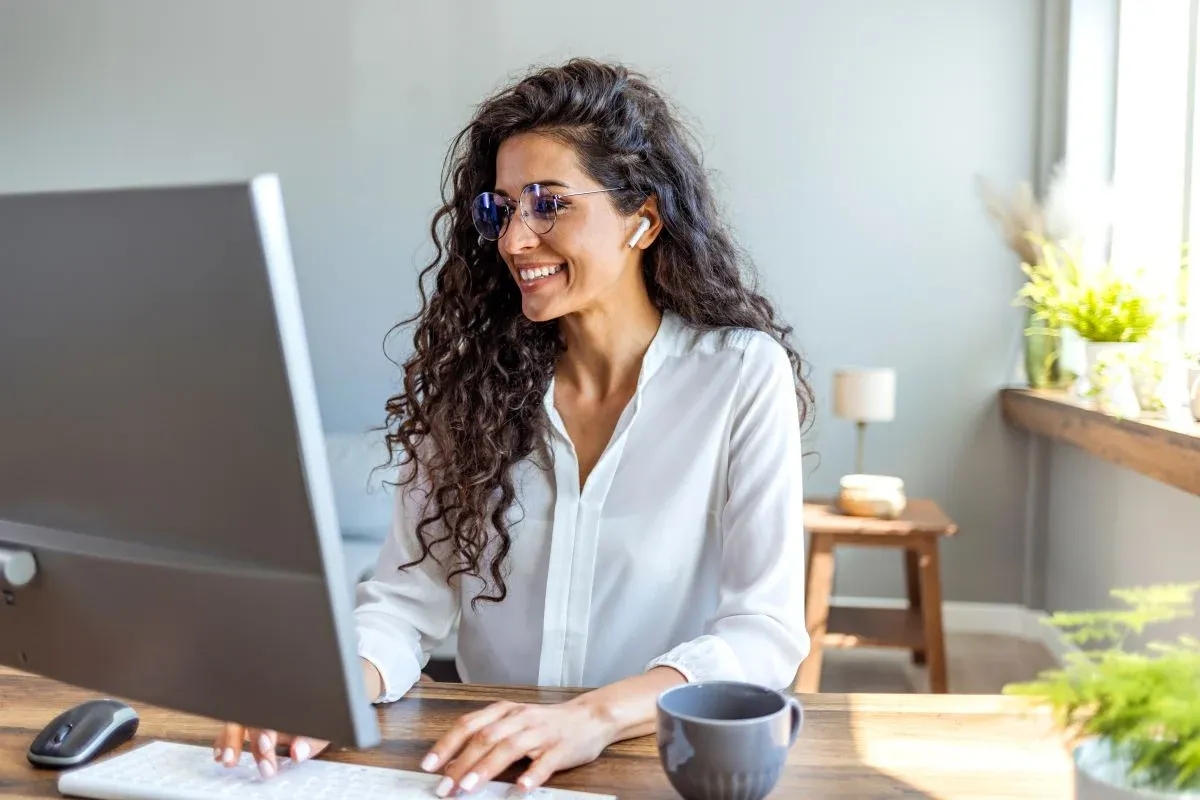 Woman working on her computer from her home