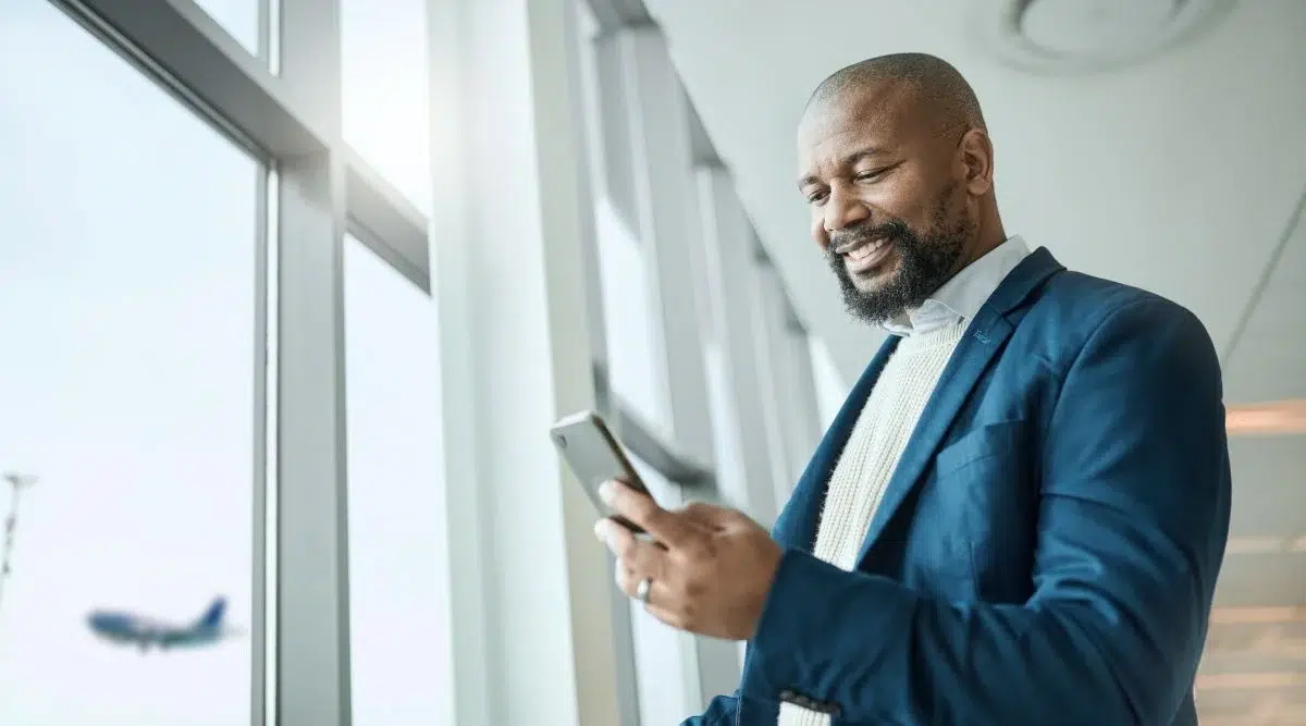 Business owner checking global mobile inventory management on his phone