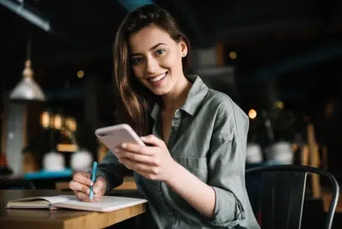 Woman writing down 4 keys to a successful UEM program