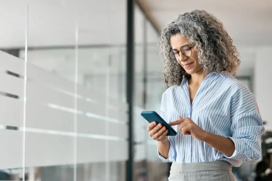 Older woman checking her API access with 5G