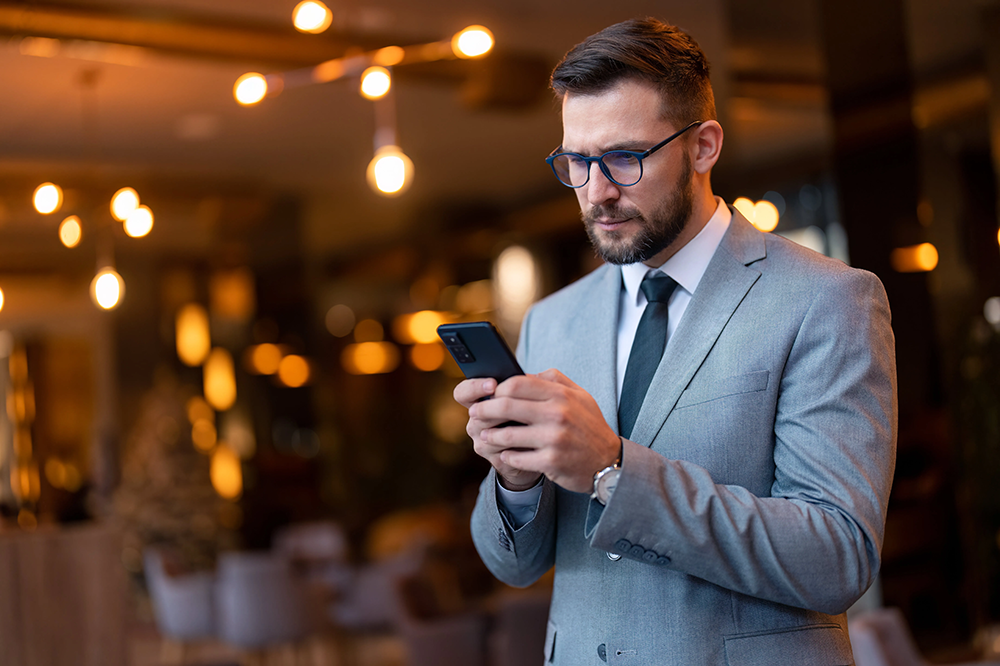 Guy Checking Mobility Management for SEC Compliance on His Phone