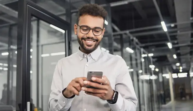 Guy with glasses watching TEM webinar on his phone